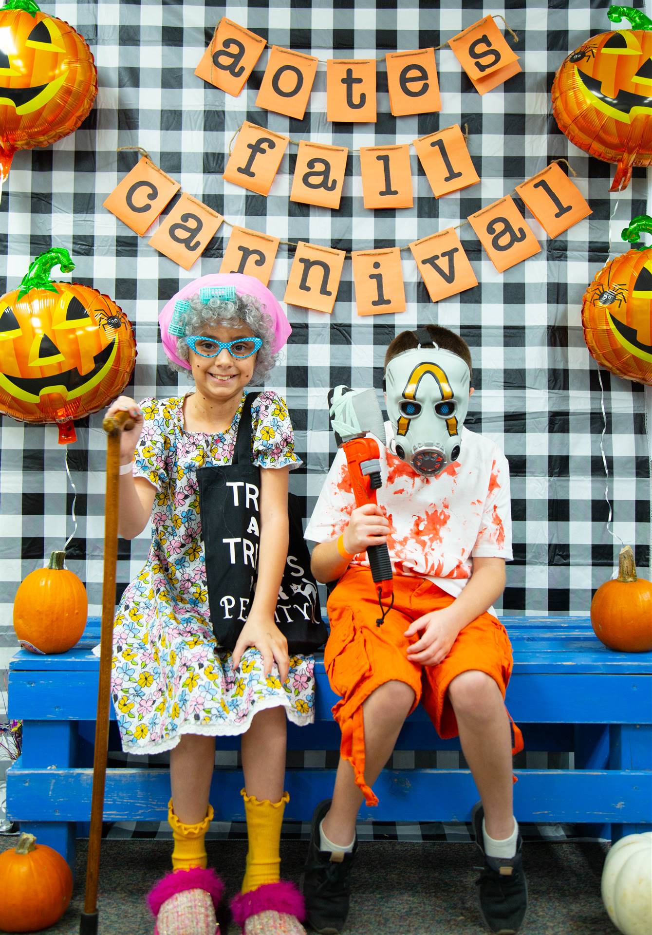 kids dressed in costume sit at photo booth